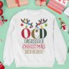 mockup of a crewneck sweatshirt surrounded by christmas decorations and gifts m16